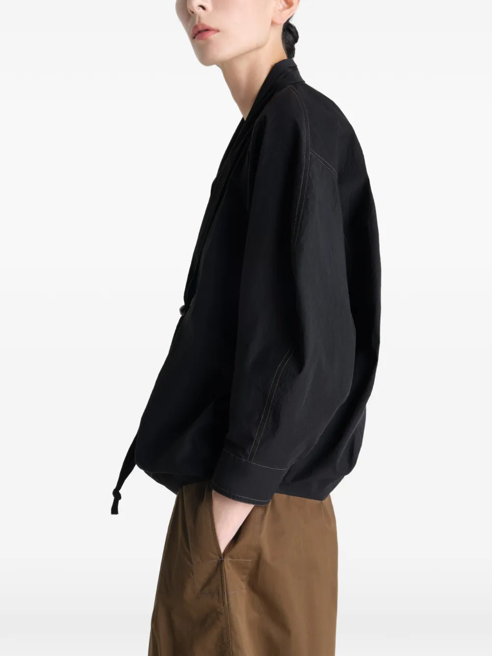 Black top worn by a person, showing the top's fit