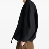 Black top worn by a person, showing the top's fit