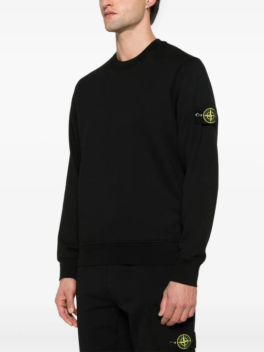 Black sweatshirt worn by a person, showing the sweatshirt fit