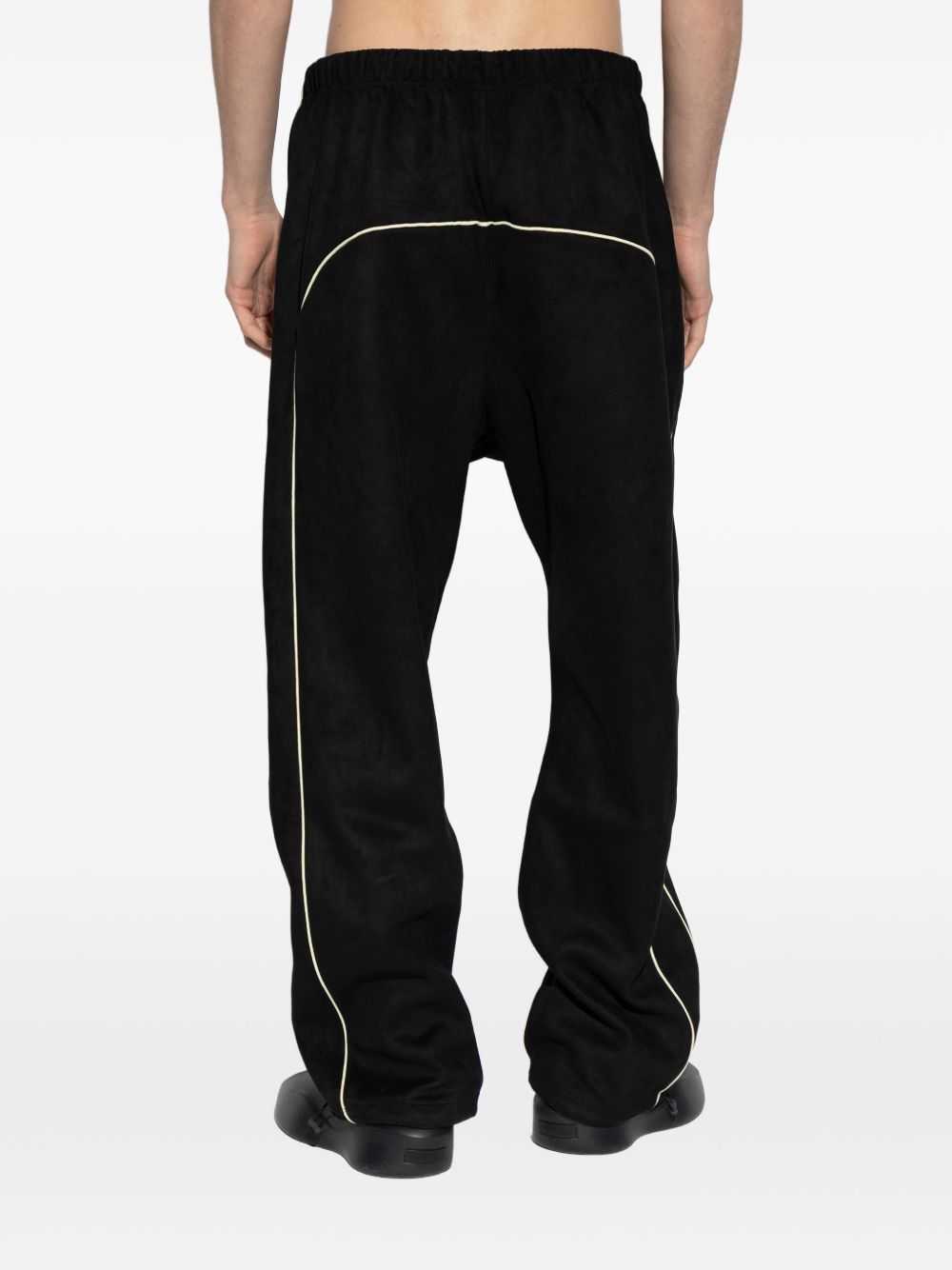 Black pants worn by a person, showing the pants' fit