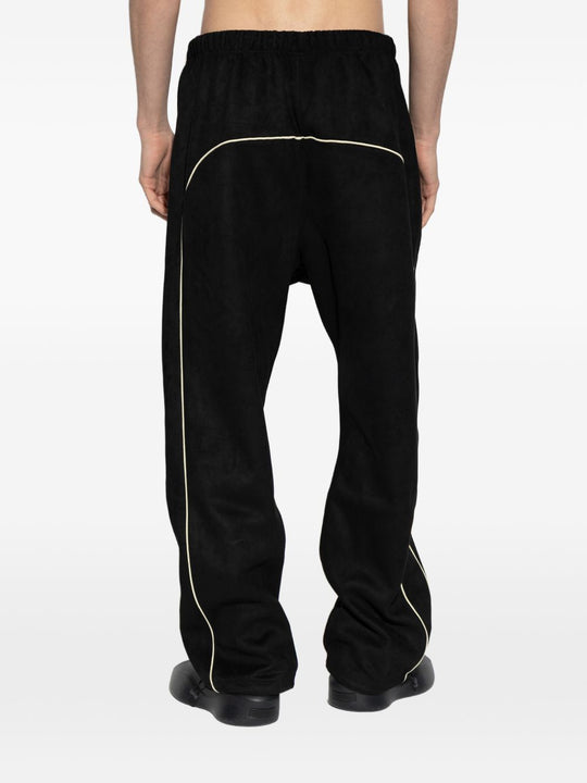 Black pants worn by a person, showing the pants' fit