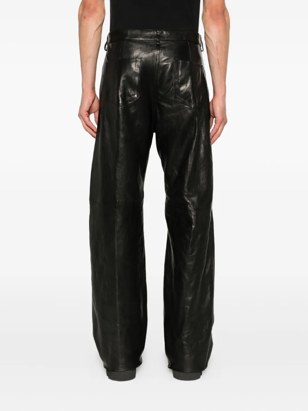 Black jeans worn by a person, showing the pants's fit