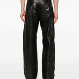 Black jeans worn by a person, showing the pants's fit