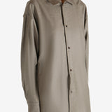 Brown shirt worn by a person, showing the shirt's fit