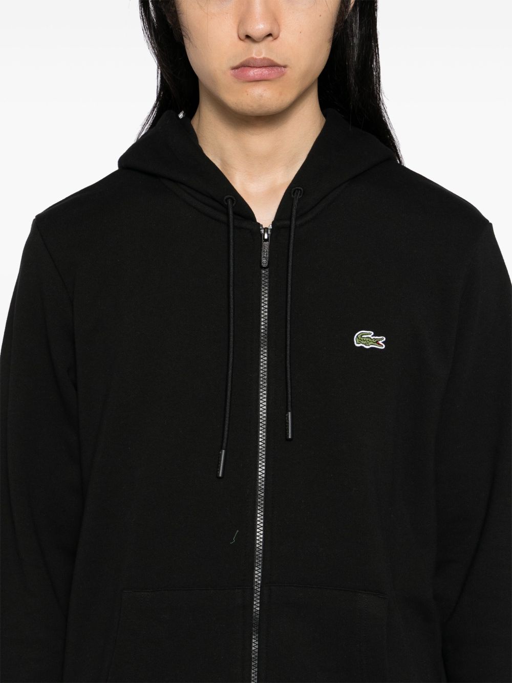 Close up of black hoodies, showing texture of the cotton fabric