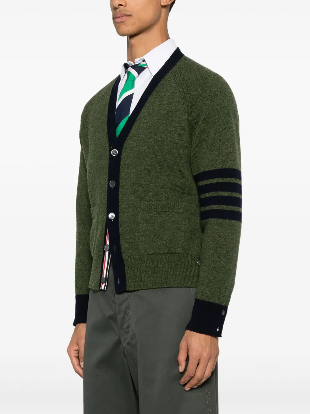 green knitwear worn by a person, showing the knitwear fit