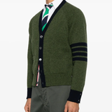green knitwear worn by a person, showing the knitwear fit