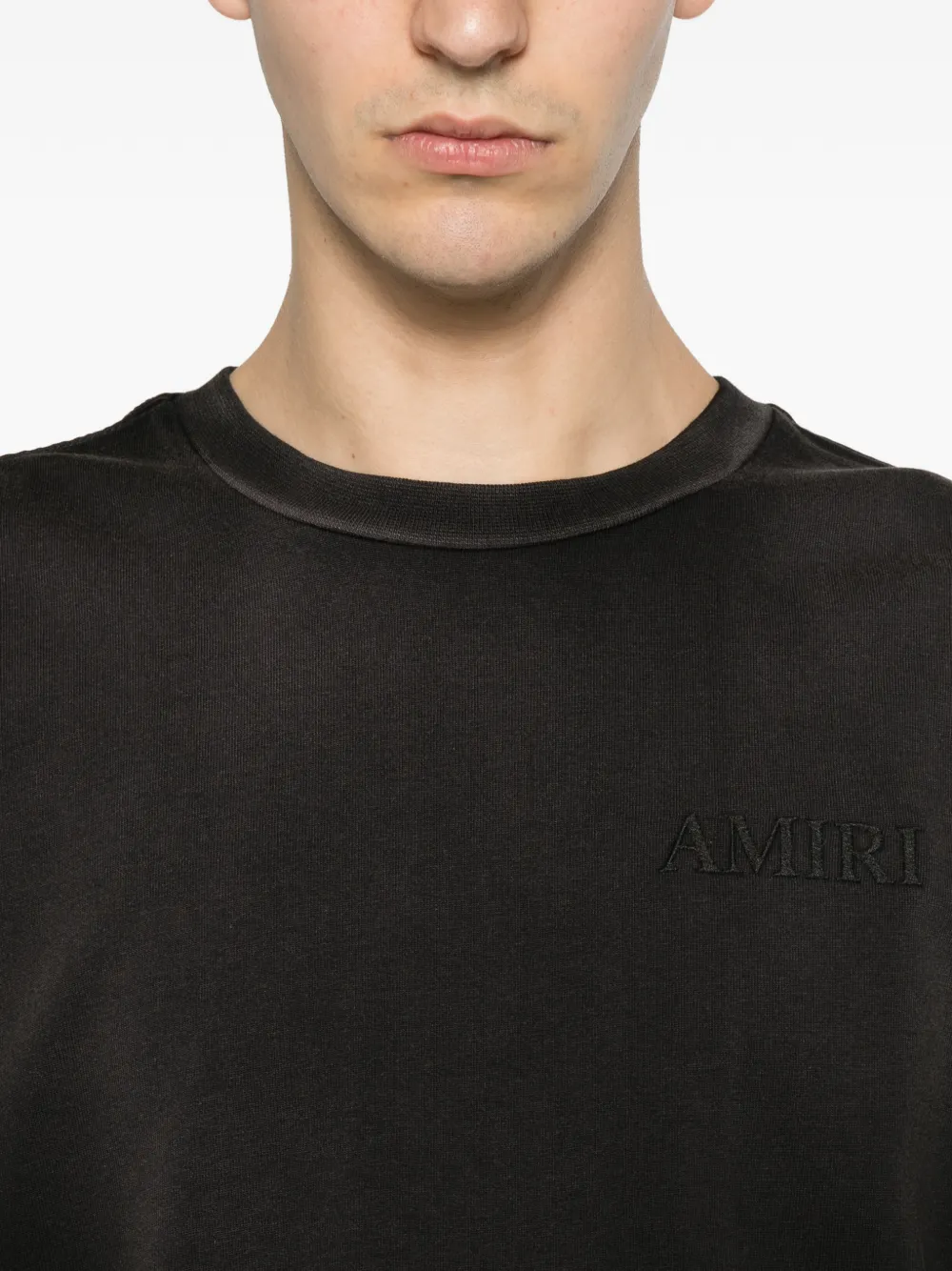 Close up of black t-shirt, showing texture of the cotton fabric