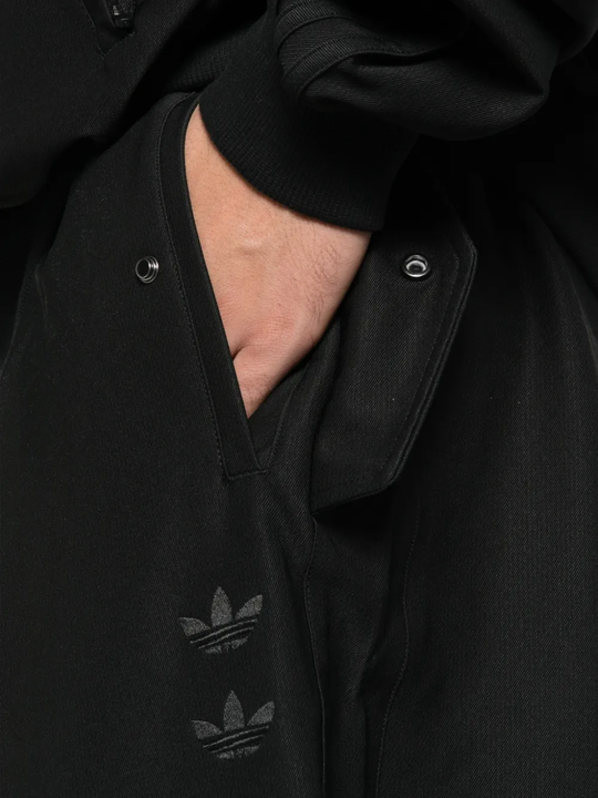 Close up of black pants, showing texture of the recycled polyester and elastane fabric