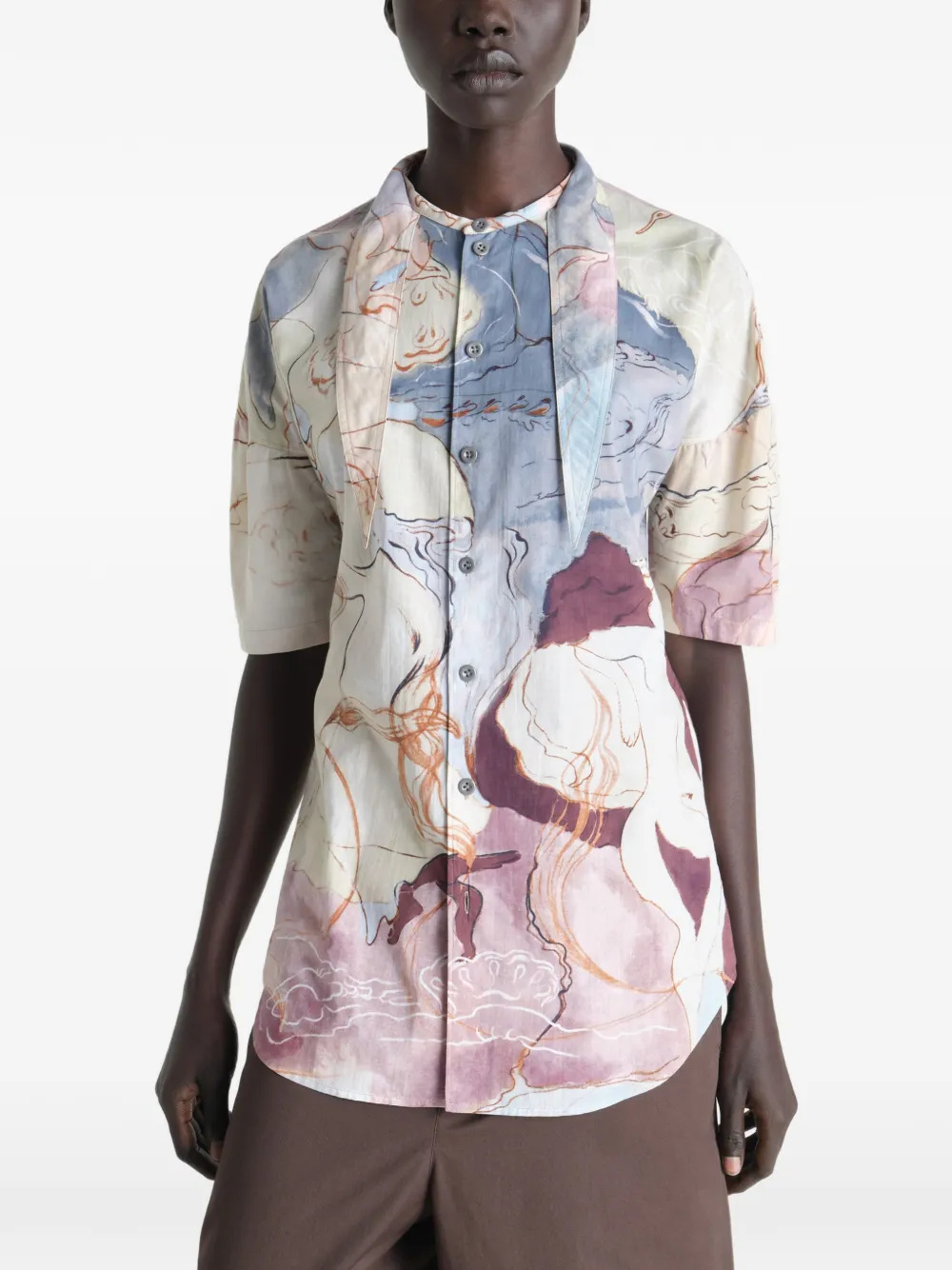 Tan shirt worn by a person, showing the shirt  fit