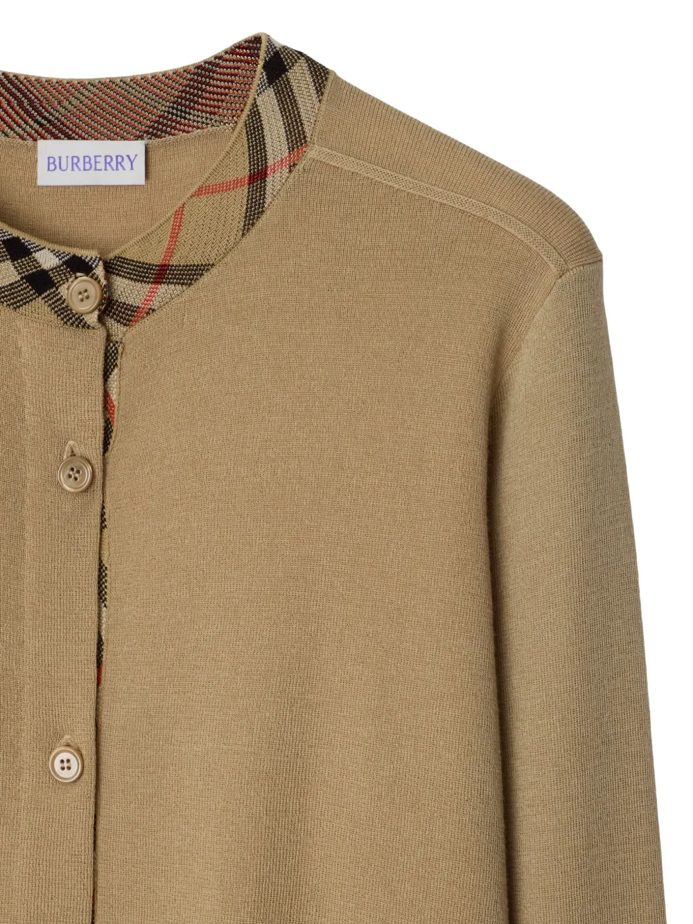 Close up of tan cardigan,showing texture of the wool fabric