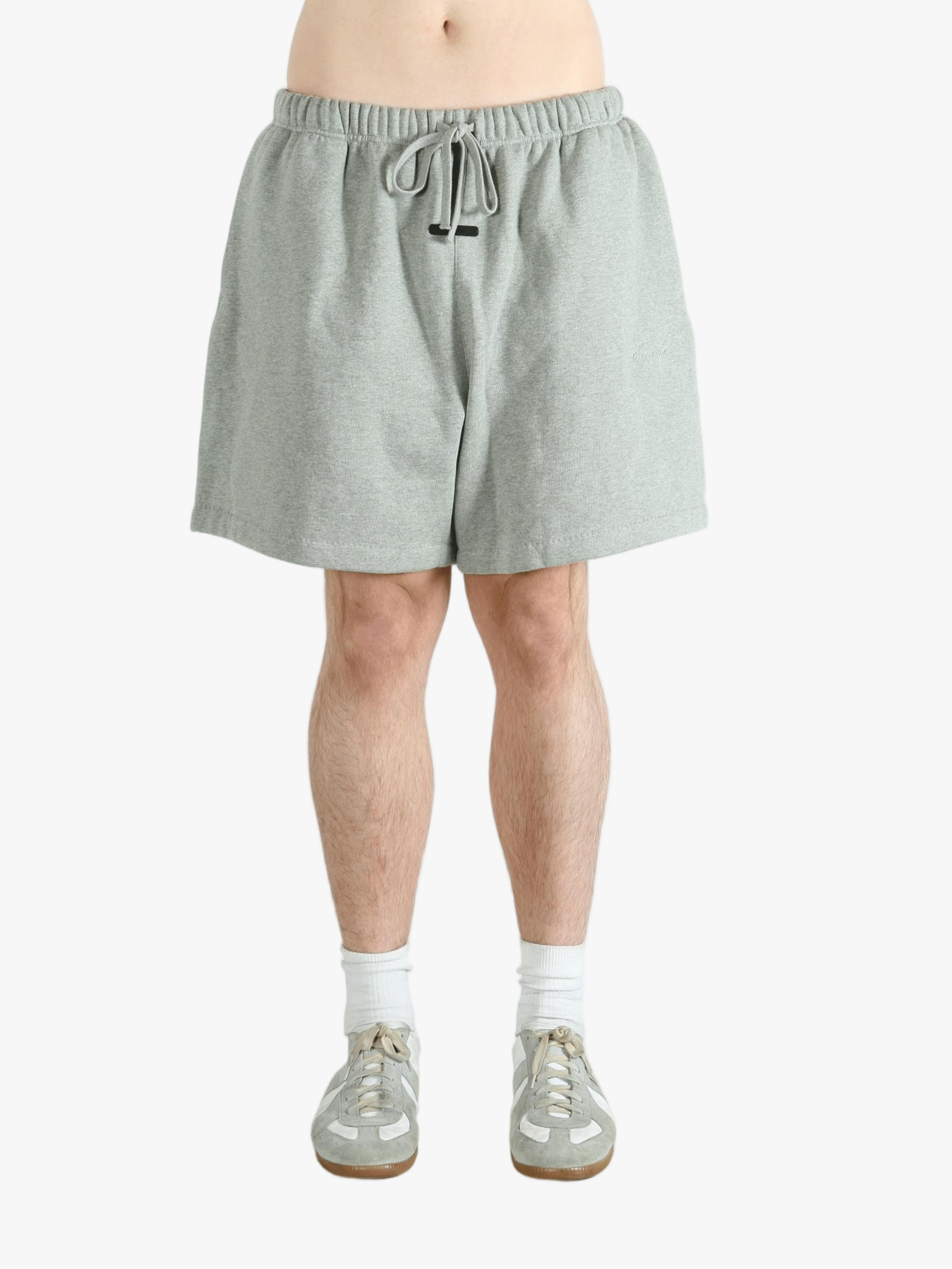 Gray shorts worn by a person, showing the short fit 