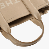 Close up of the brown bag, showing texture of the leather fabric