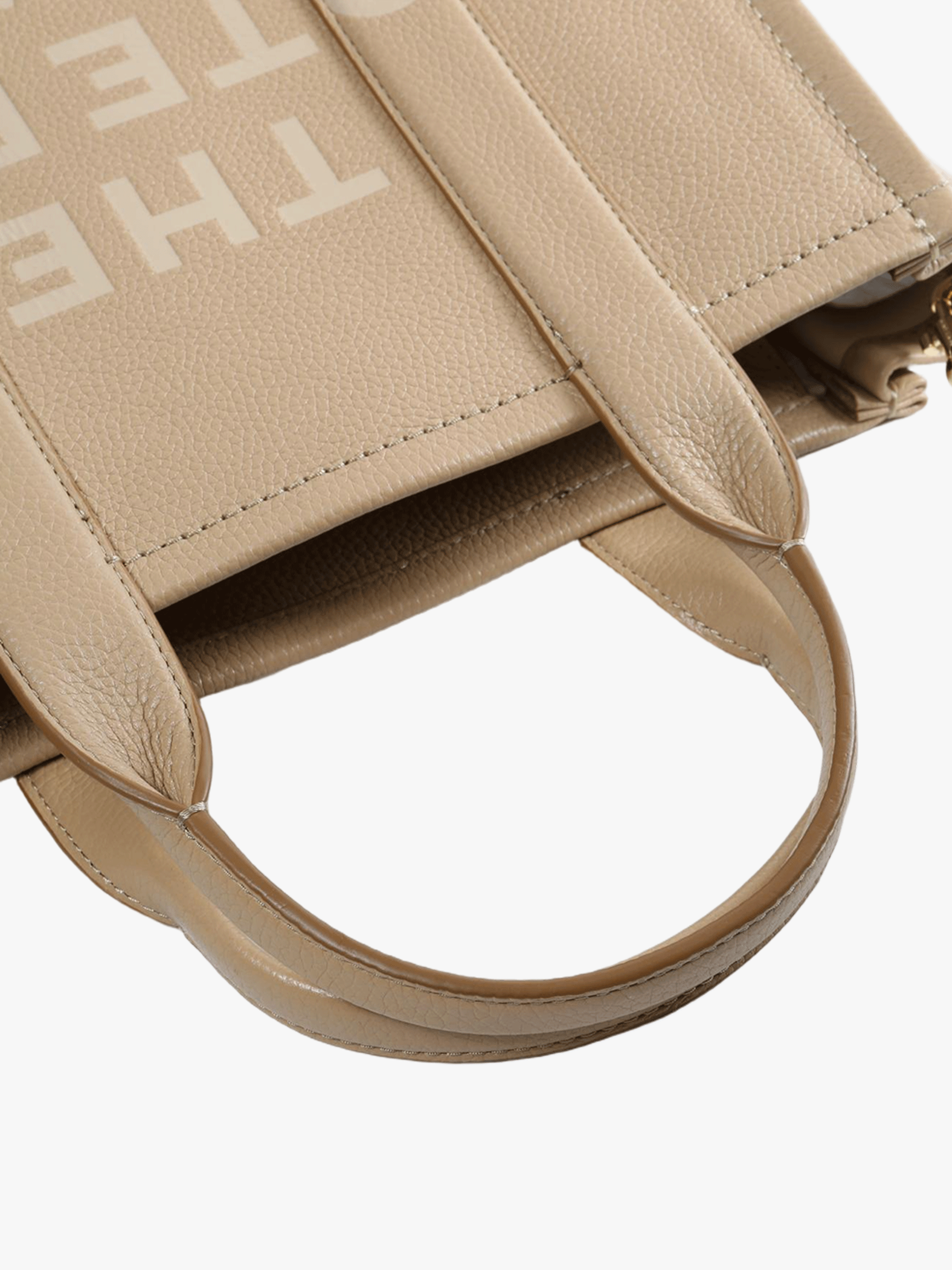 Close up of the brown bag, showing texture of the leather fabric