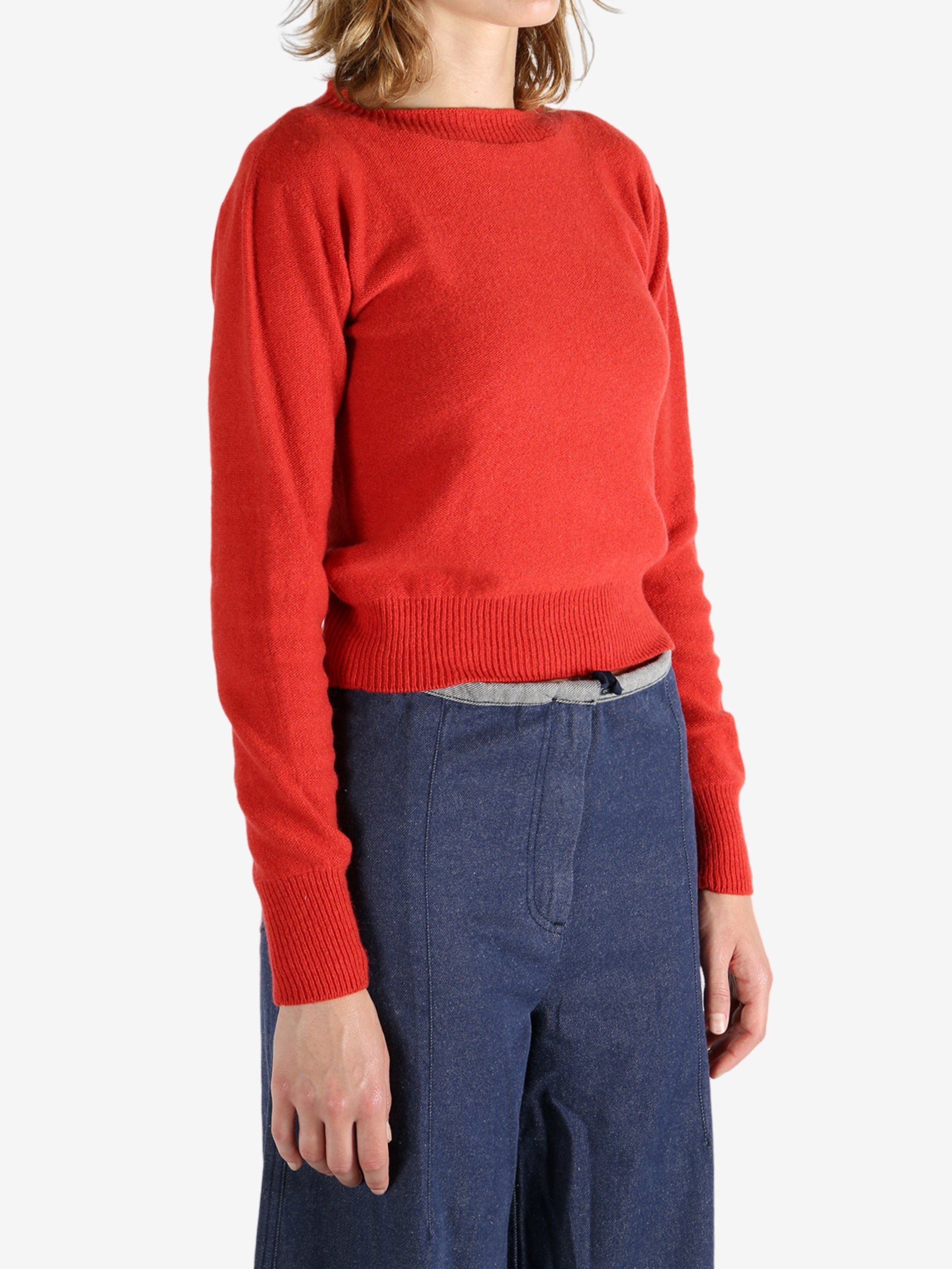 Red sweater worn by a person, showing the sweater fit