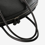 Close up of black bag, showing metallic zip closure