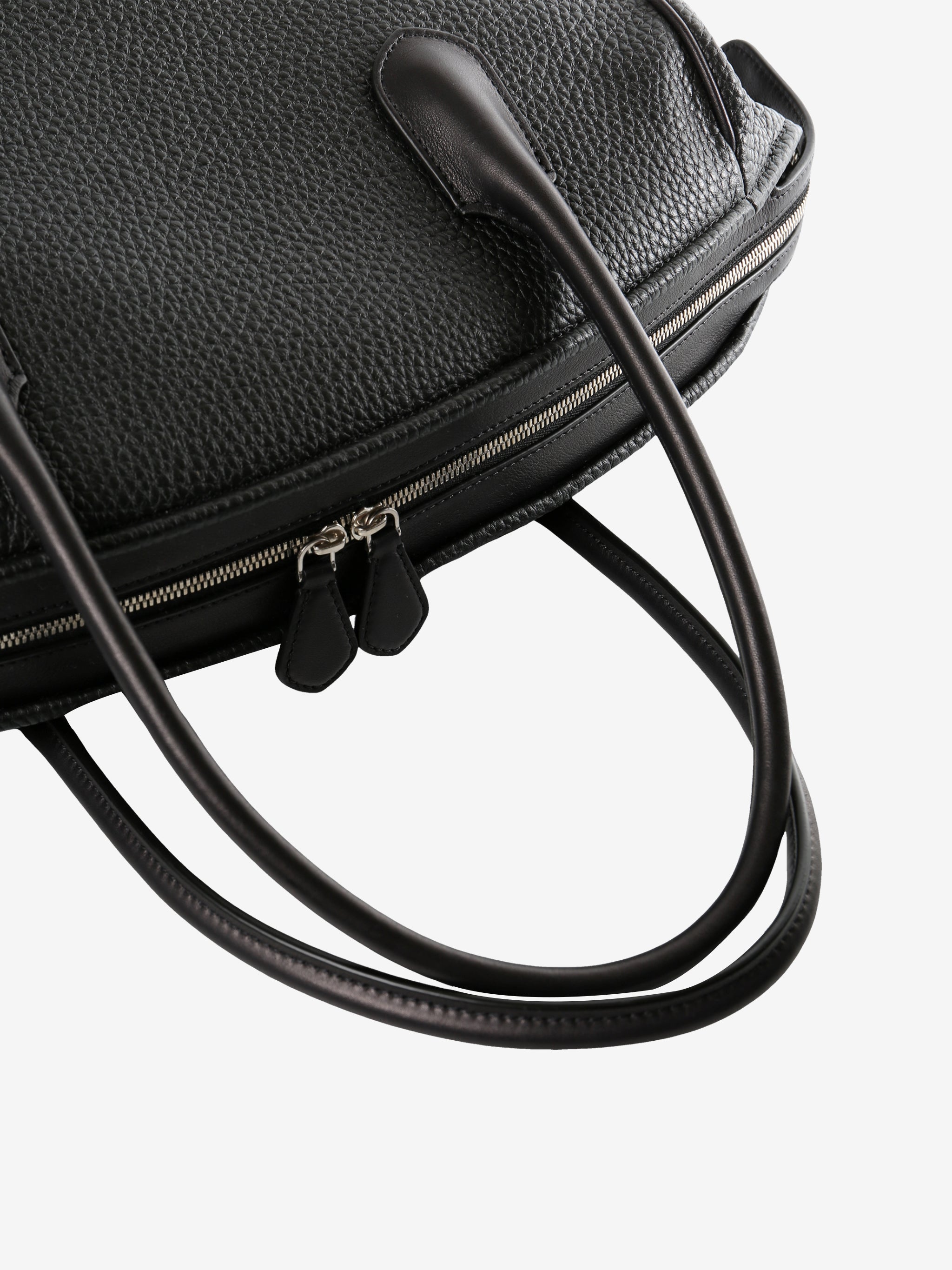 Close up of black bag, showing metallic zip closure
