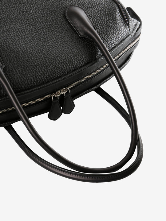 Close up of black bag, showing metallic zip closure