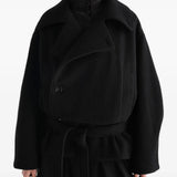 Black jacket worn by a person, showing the jacket fit