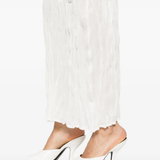 Close up of white skirts, showing texture of the crinkled