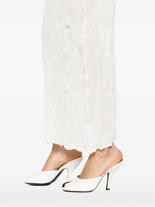 Close up of white skirts, showing texture of the crinkled