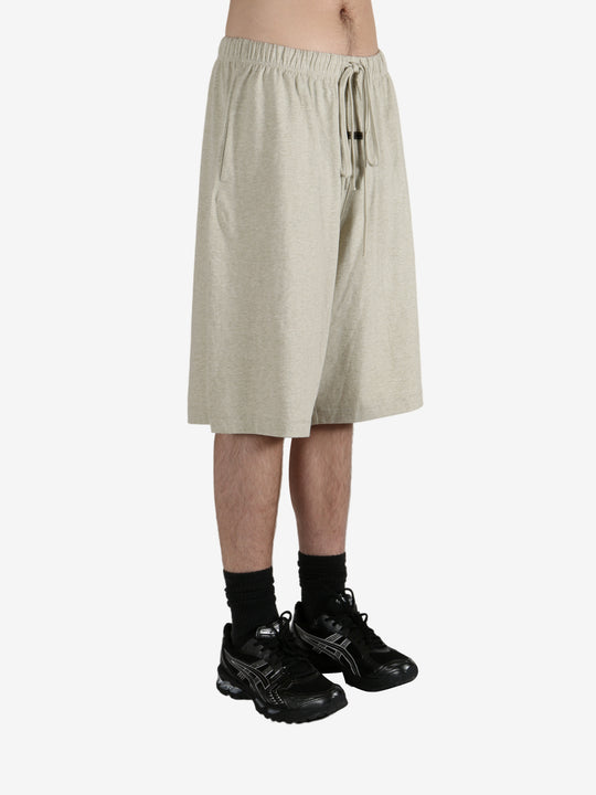 Grey shorts worn by a person, showing the shorts fit