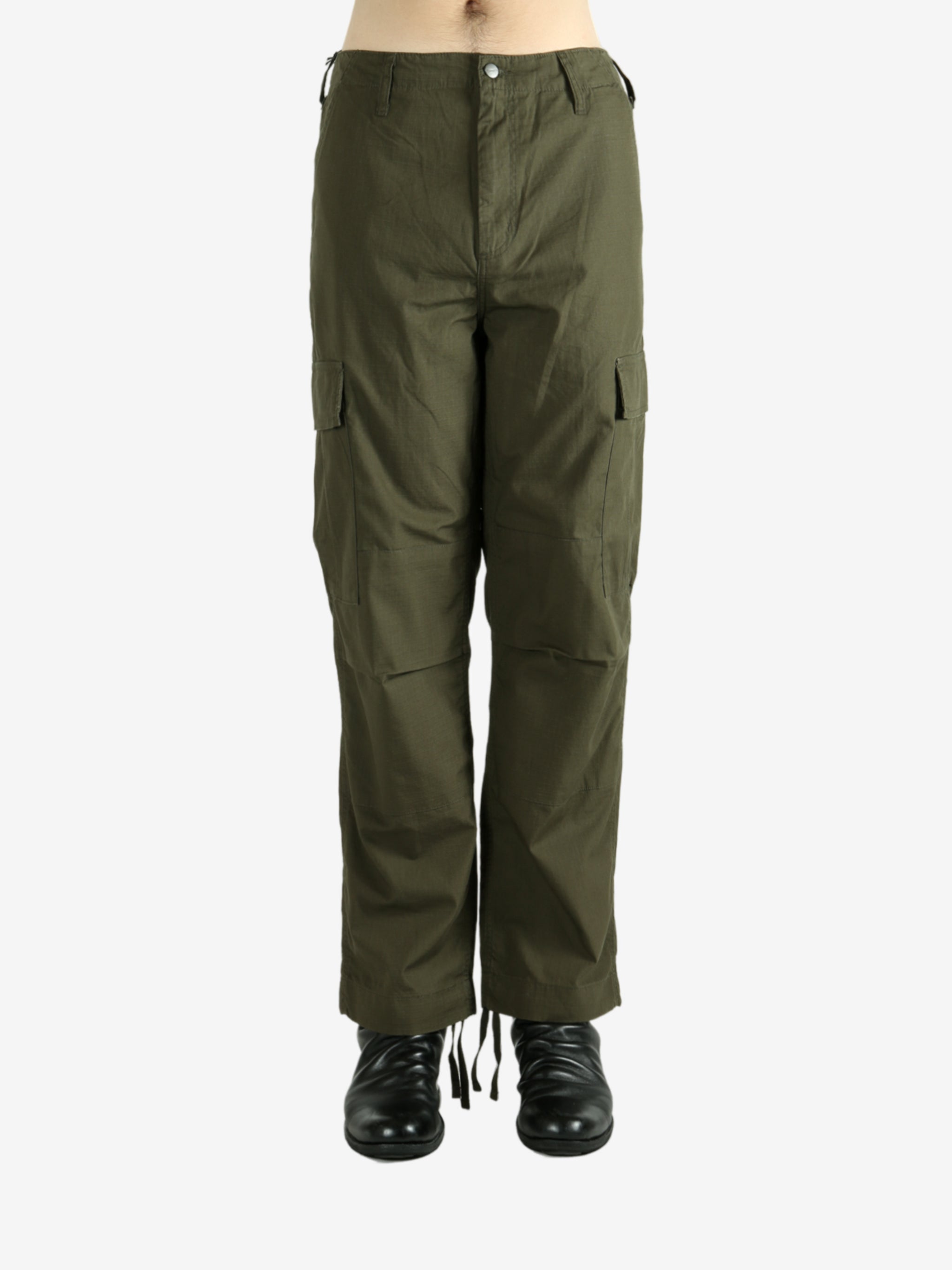 Green pants worn by a person, showing the pants's fit