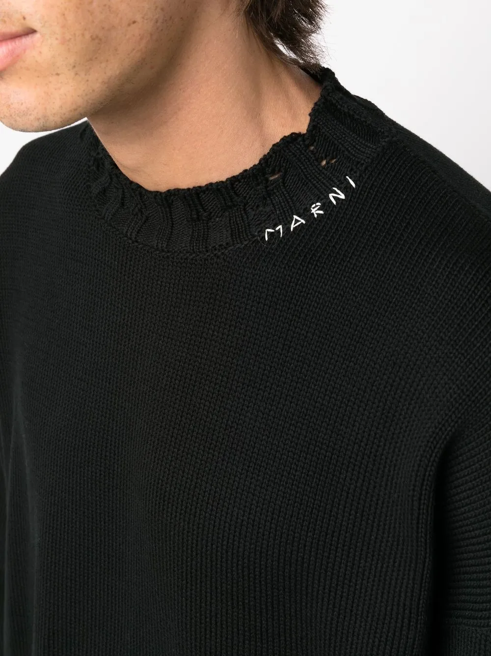 Close up of the black sweater, showing texture of the cotton fabric
