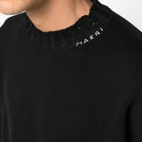 Close up of the black sweater, showing texture of the cotton fabric