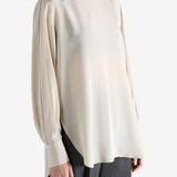 White top worn by a person, showing the top's fit