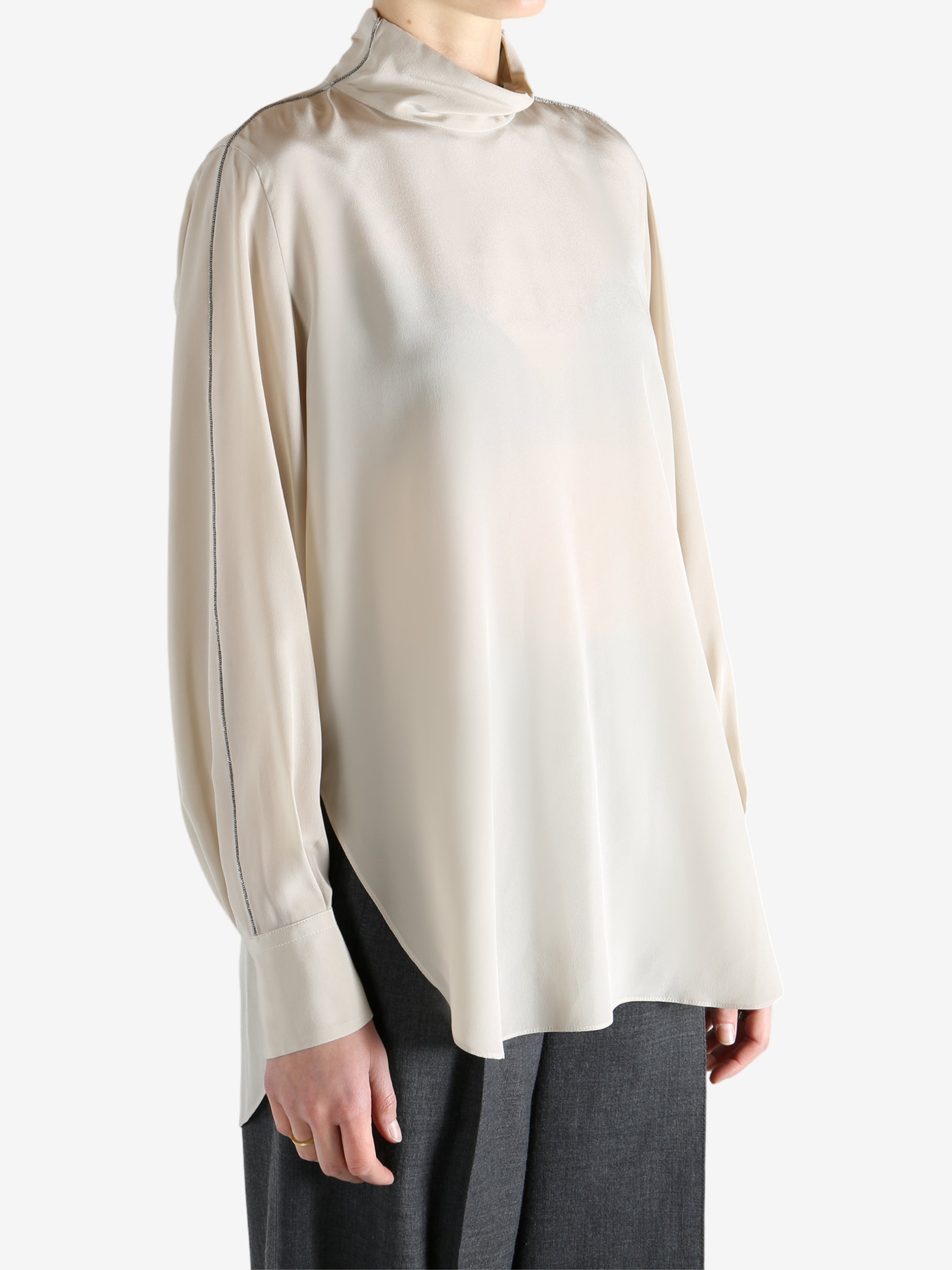 White top worn by a person, showing the top's fit