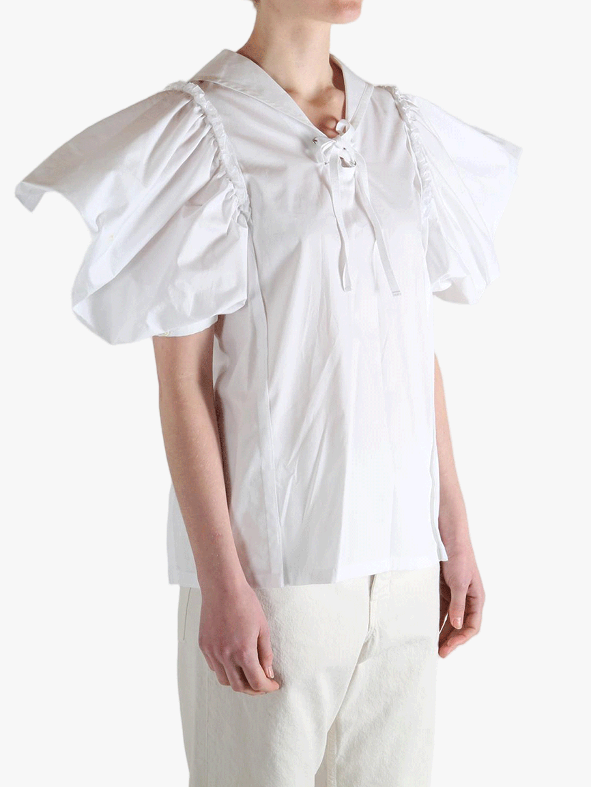 White top worn by a person, showing the top fit