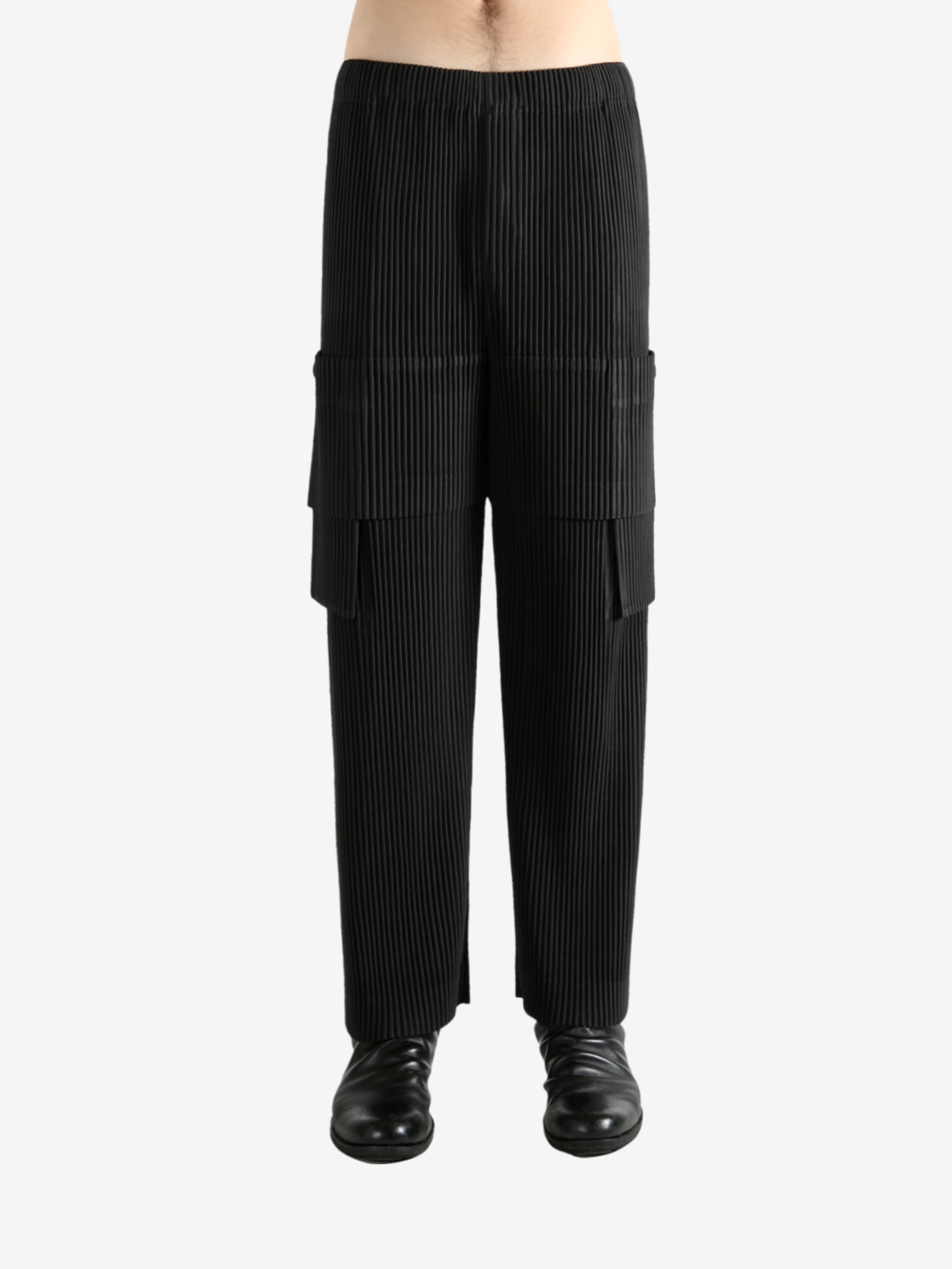 Black pants worn by a person, showing the pant's fit