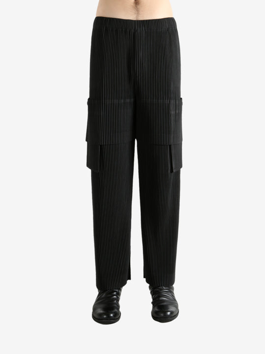 Black pants worn by a person, showing the pant's fit