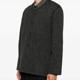 Grey knitwear worn by a person, showing the knitwear fit