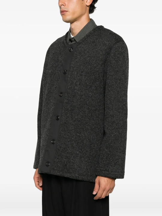 Grey knitwear worn by a person, showing the knitwear fit