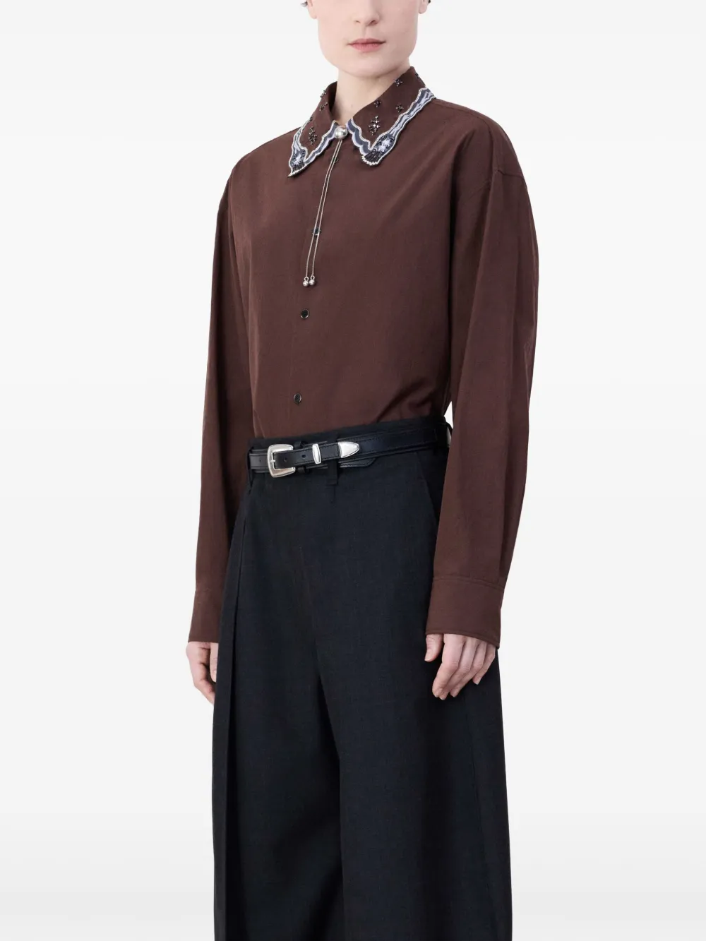 Black belt worn by a person, showing the belt fit