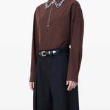 Black belt worn by a person, showing the belt fit