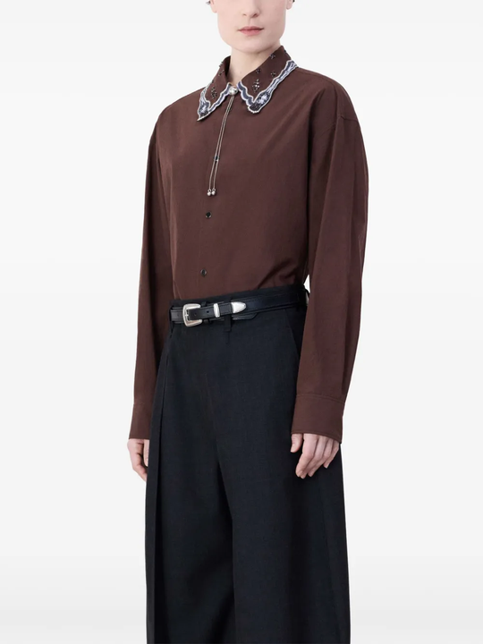 Black belt worn by a person, showing the belt fit