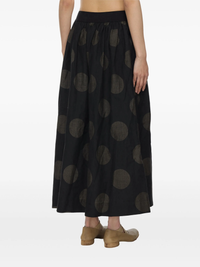 Black midi skirt worn by a person, showing the skirt fit