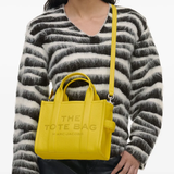 Yellow bags worn by a person, showing the bags' fit
