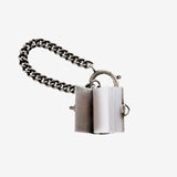 Close up of the grey charm, showing texture of the silver fabric