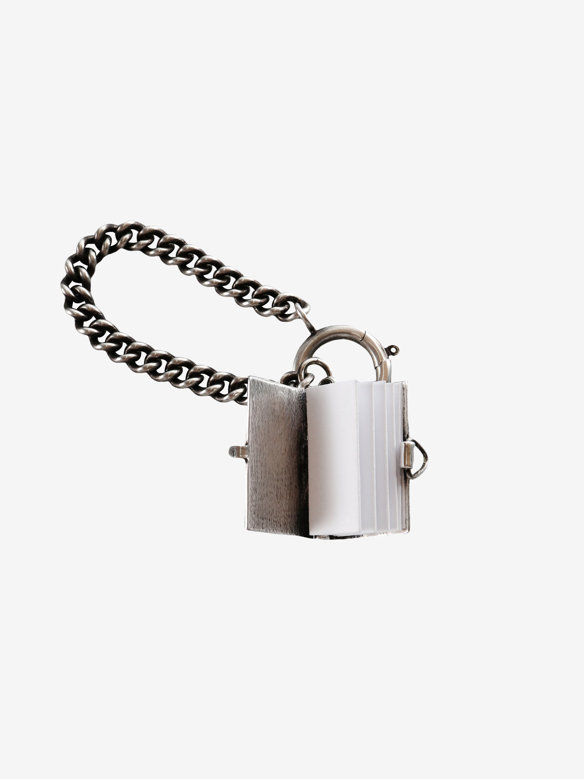 Close up of the grey charm, showing texture of the silver fabric