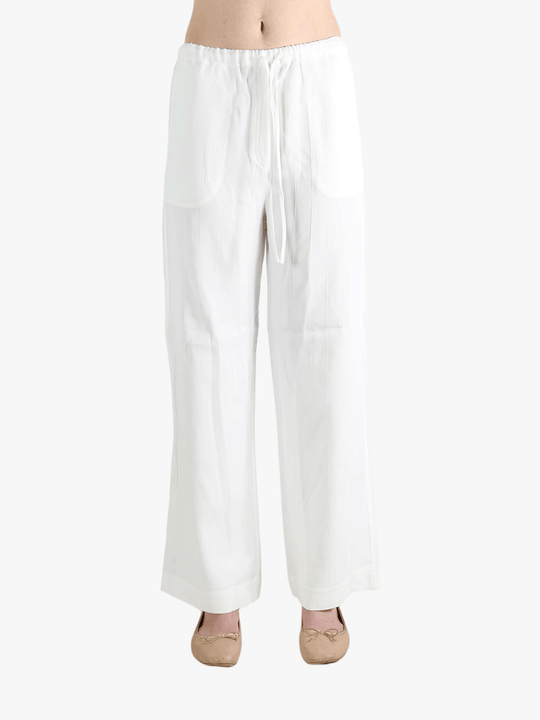 white pants worn by a person, showing the pants  fit