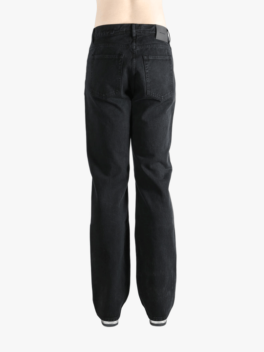 Black pant worn by a person, showing the pant's fit