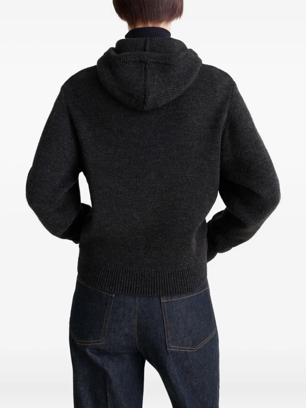 Black sweater worn by a person, showing the sweater fit