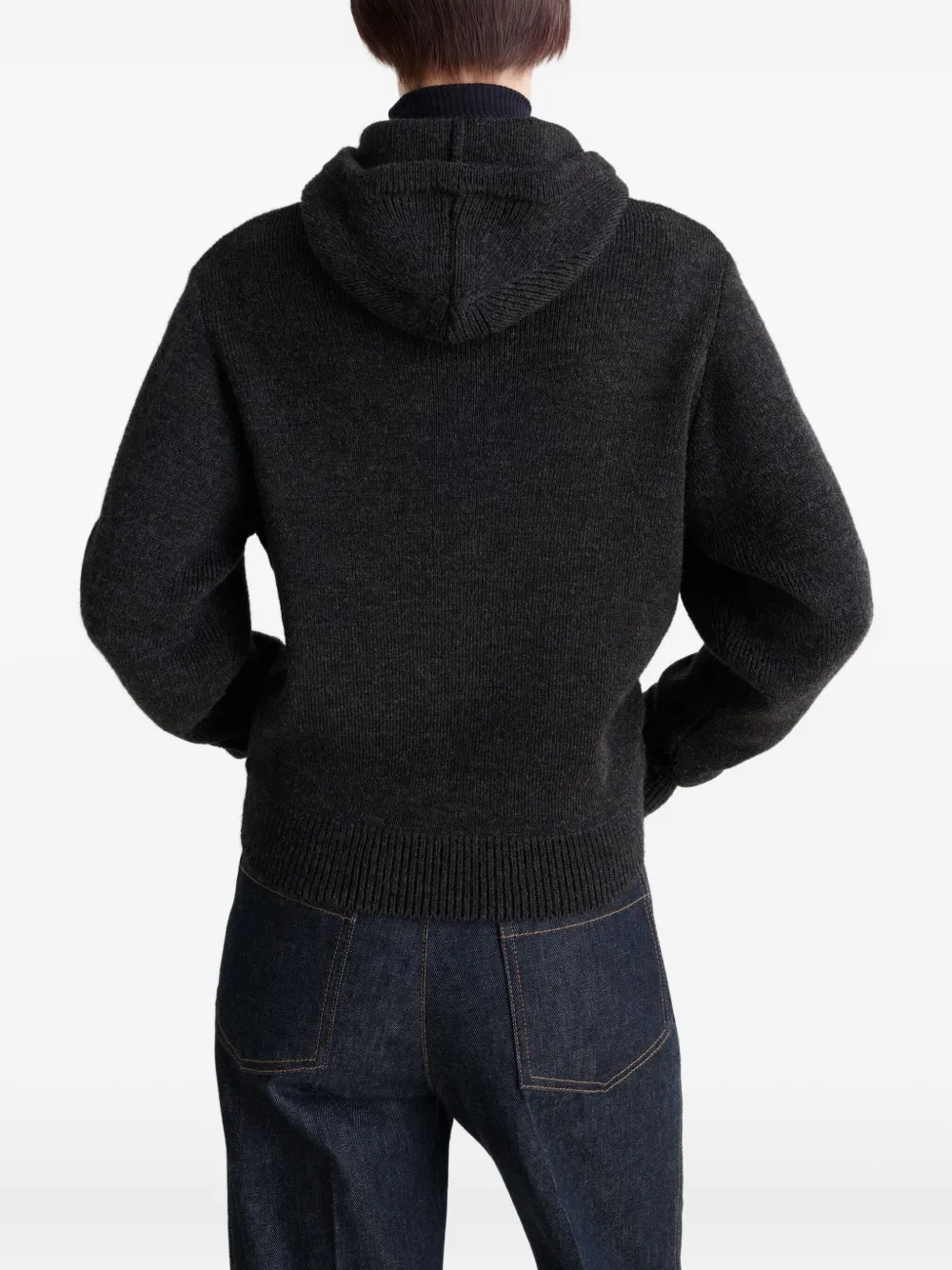 Black sweater worn by a person, showing the sweater fit