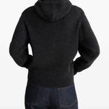 Black sweater worn by a person, showing the sweater fit