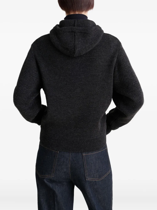 Black sweater worn by a person, showing the sweater fit