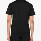 Black t-shirts worn by a person, showing the t-shirts fit